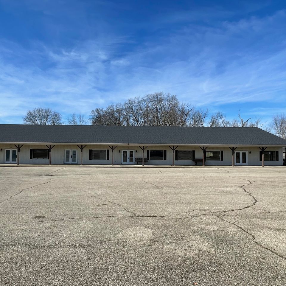 Large commercial building featuring a professionally installed low-slope roofing system by E & D Roofing, Inc.