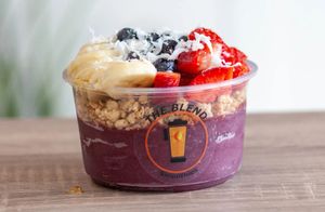 Acai, Yes! bowl with acai base, strawberries, banana, blueberries, granola, coconut, and honey.