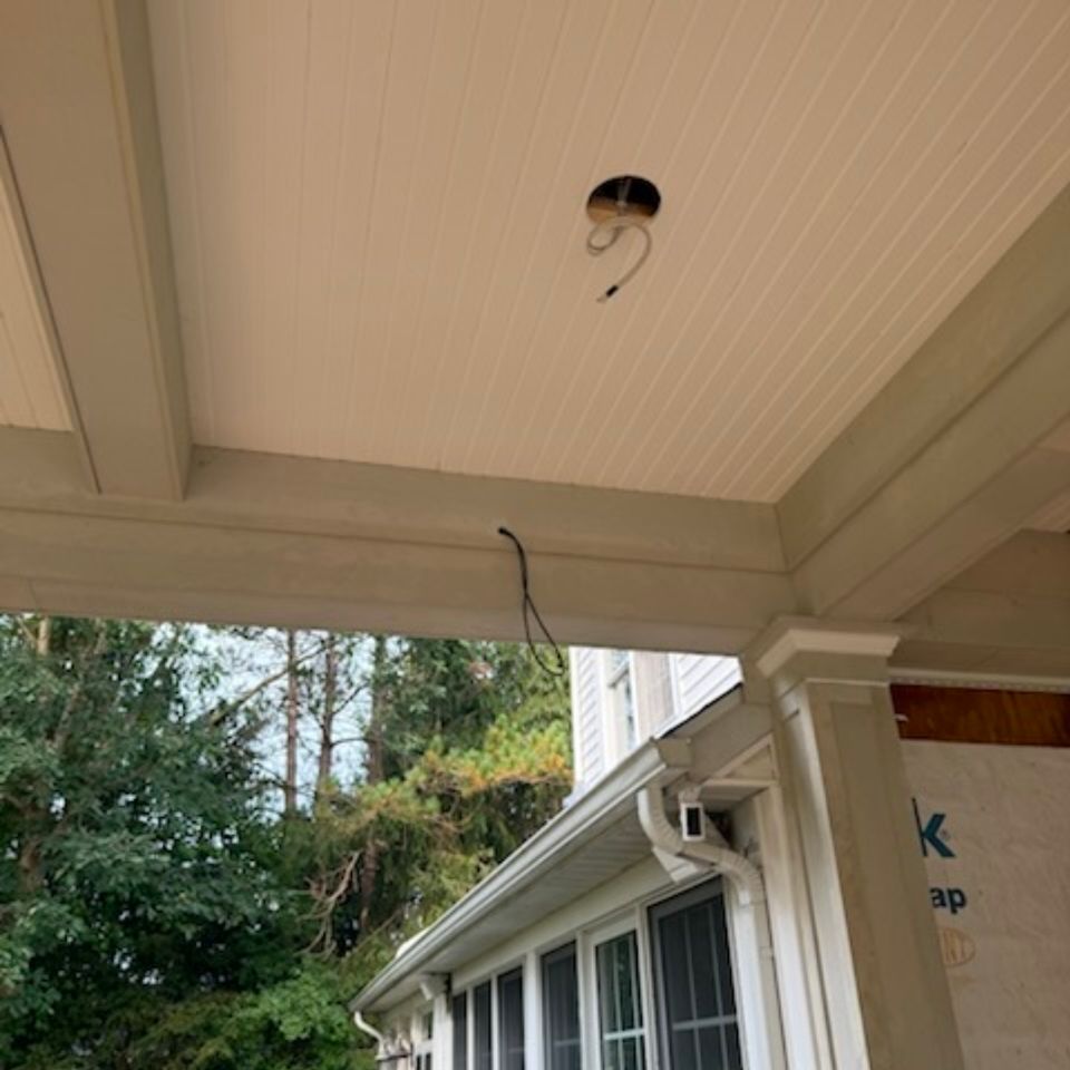 Beadboard porch ceiling with trimmed beams and wiring prepped for a light fixture