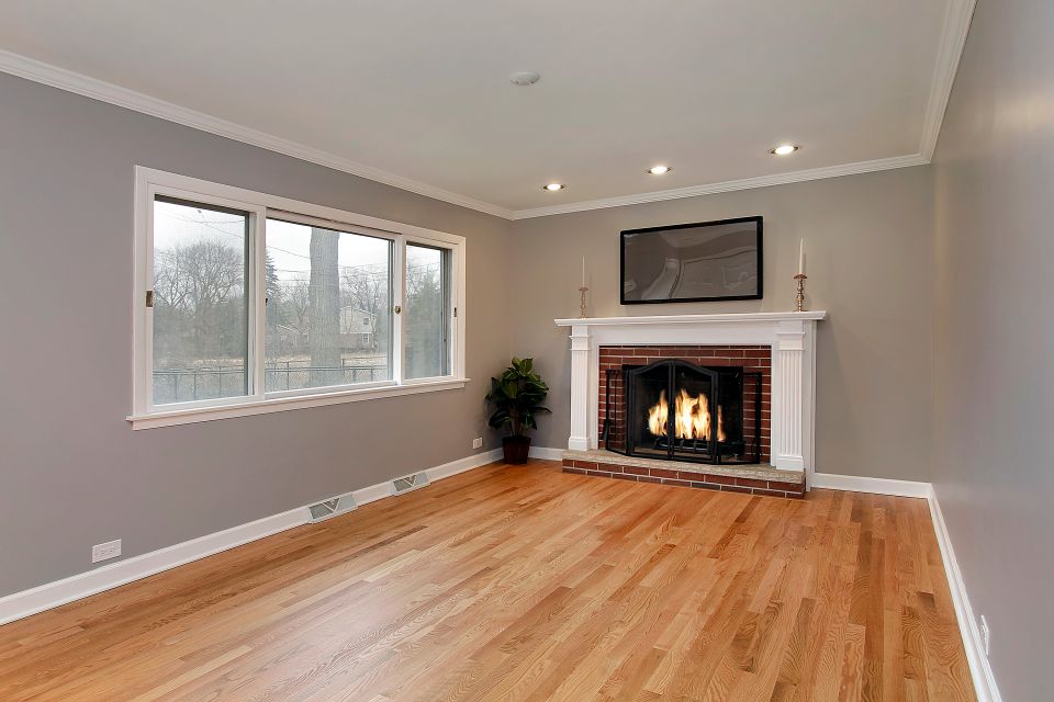 Family room in remodeled home with brick fireplace