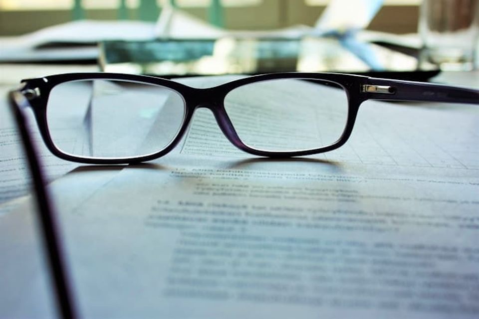 black frame glasses on a law firm marketing report