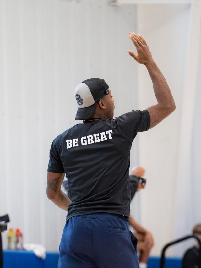 Xavier Allen wearing a shirt that says "be great" on the back