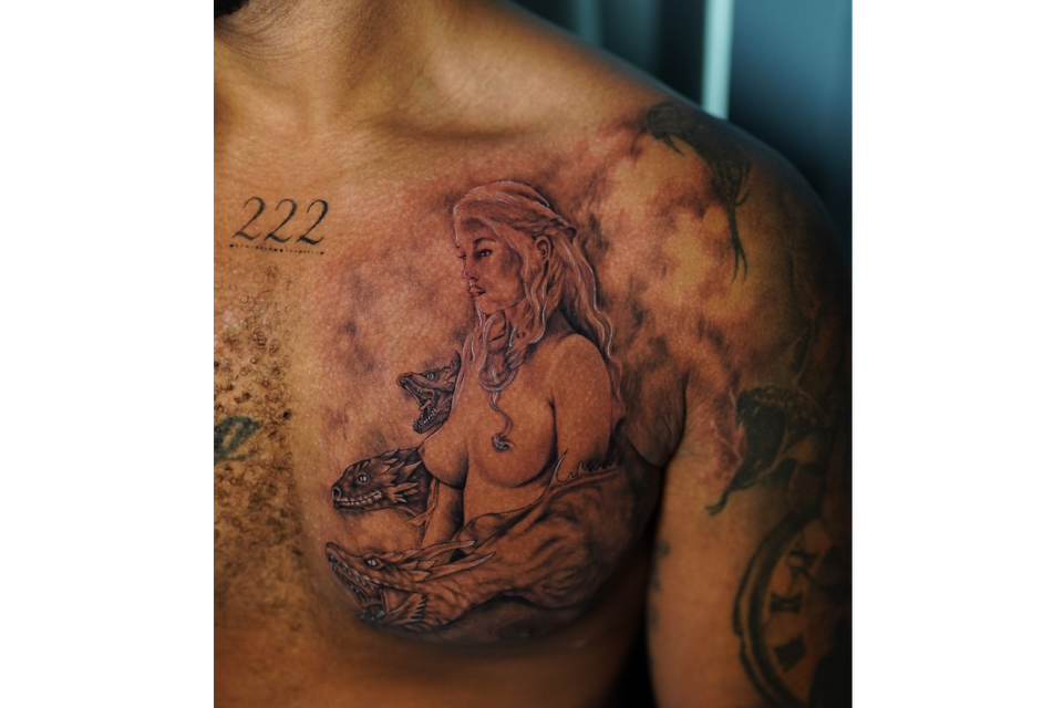 Image of a very detailed tattoo of a woman with serpents and clouds and very rich detail in this tattoo