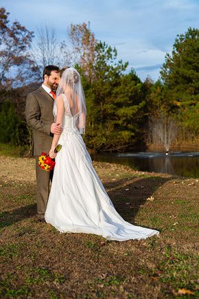 Bride and groom by pond