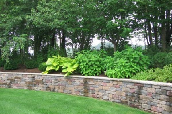 Segmental block retaining wall with steps and plantings