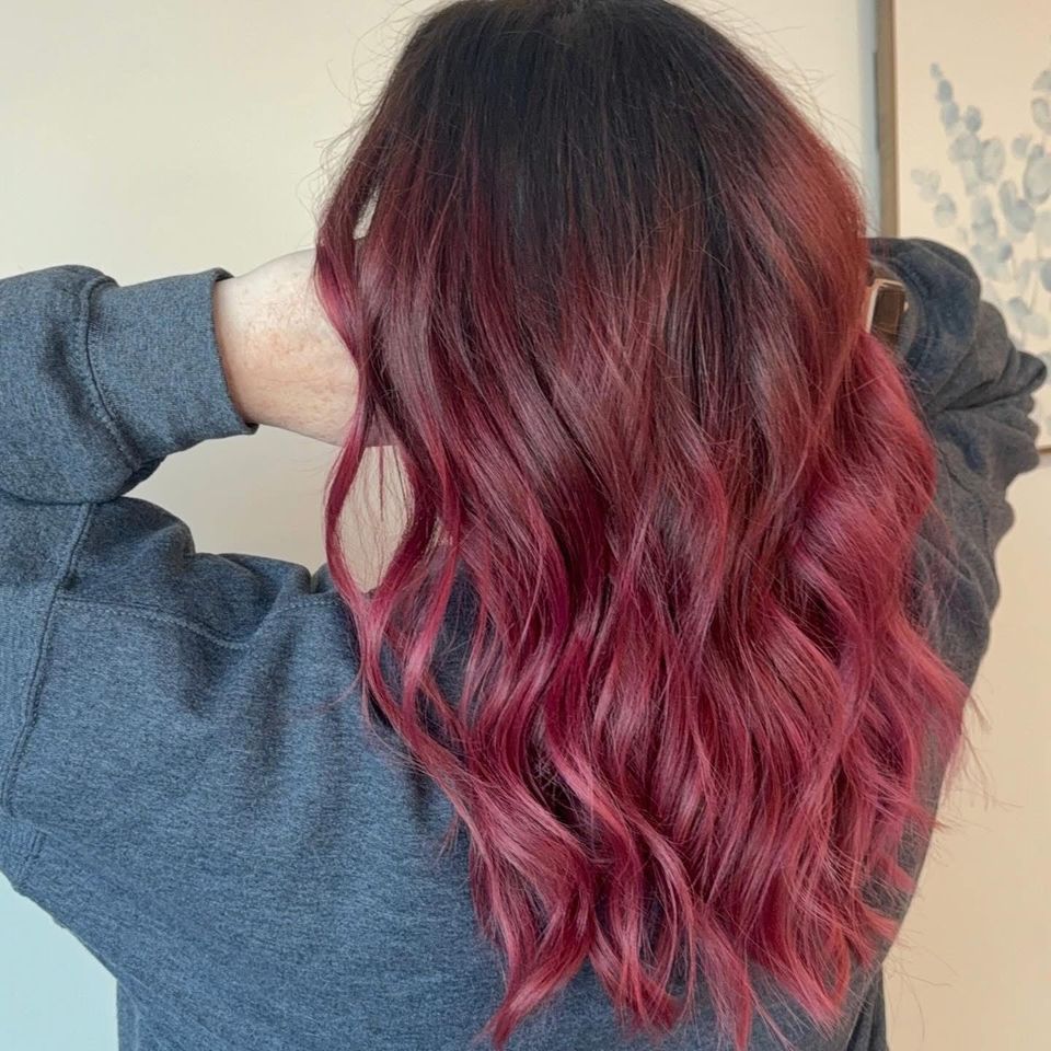 Long wavy dark to red ombre with vibrant burgundy ends after color service in Columbiana AL