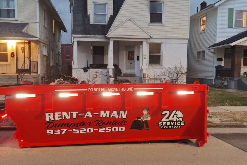 Rent-A-Man Dumpster Rentals dumpster set in front of a residential property.