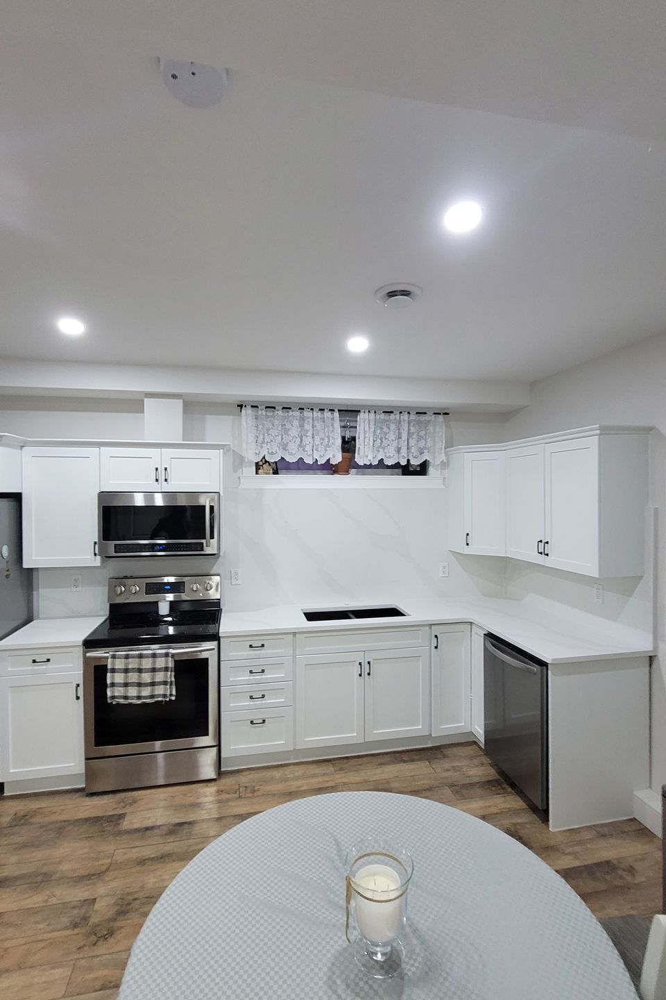 Bright kitchen with white countertop and tables