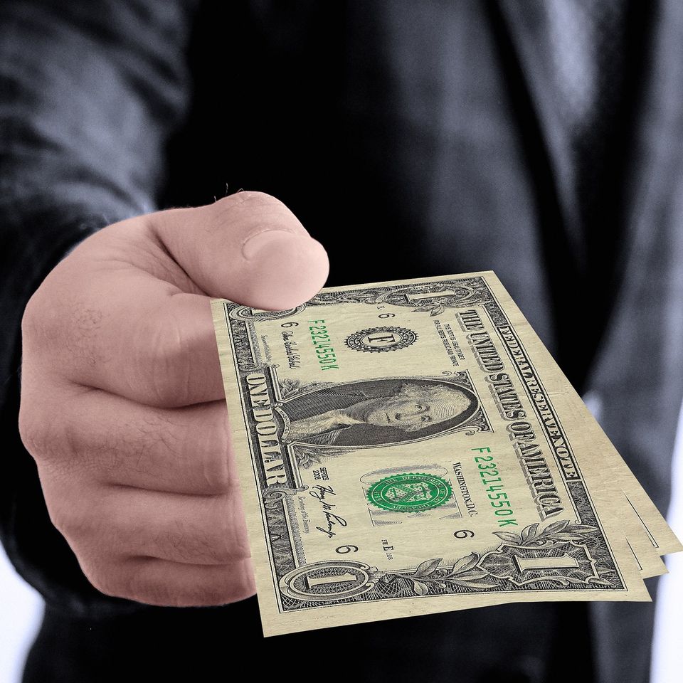 Person handing cash to represent fast payment for eligible diabetic test strips and CGM sensors.