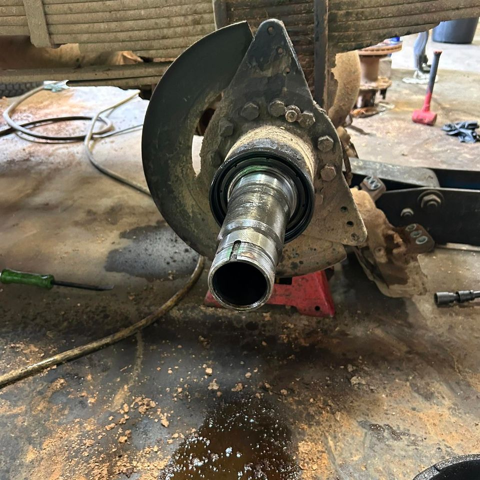 Semi-truck axle spindle and hub exposed during wheel bearing service in Arab Alabama