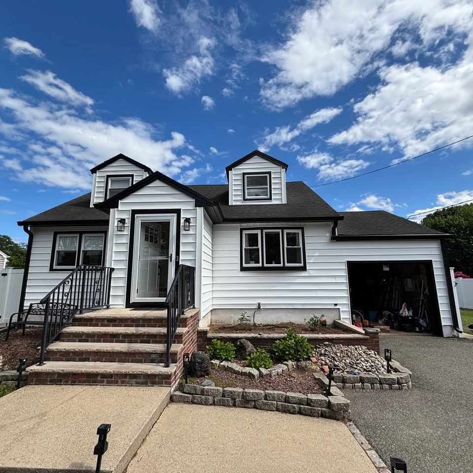 house with white siding and custom masonry work