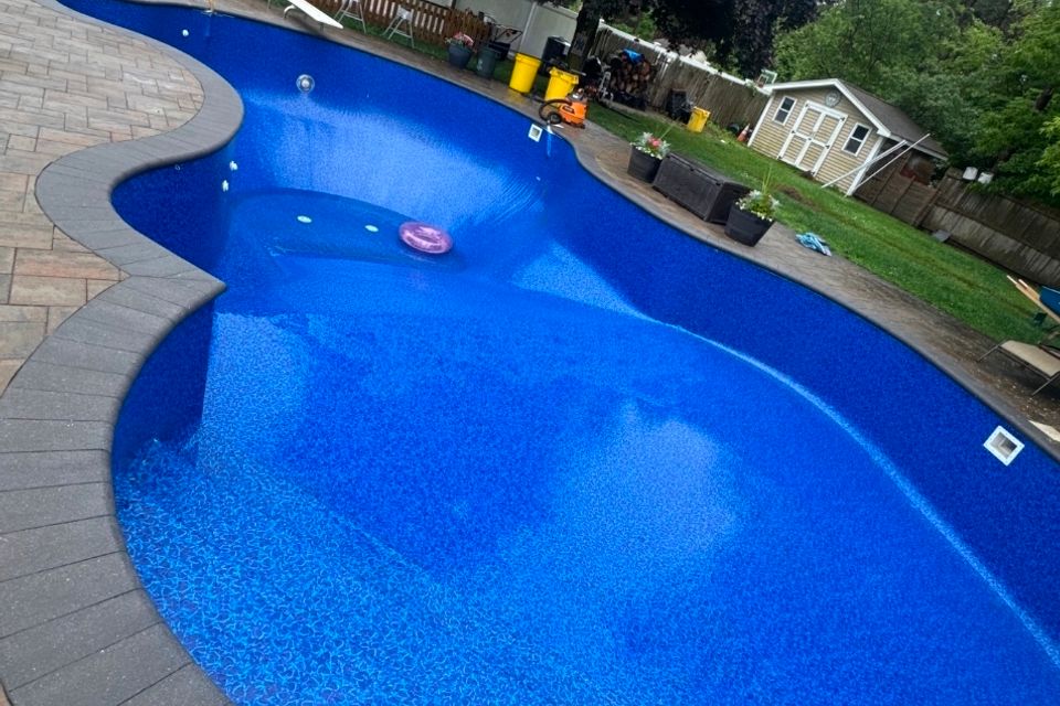 Completed liner replacement on a curved inground pool with paver coping in Long Island NY
