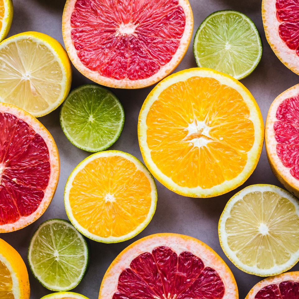 Assorted citrus fruits, sliced and whole, representing vitamin-rich IV drips