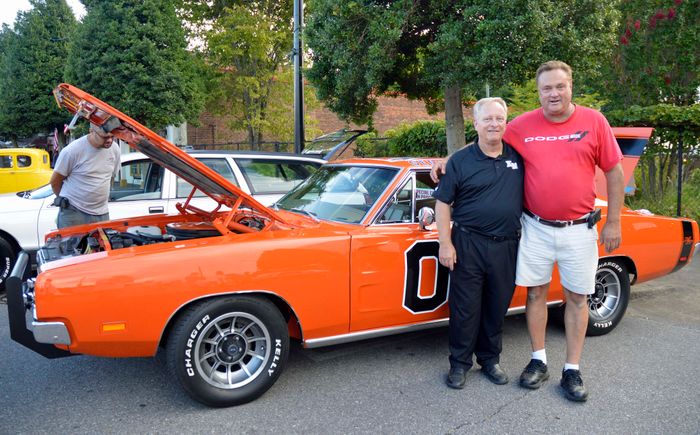 Mayor posing with the dukes of hazard car