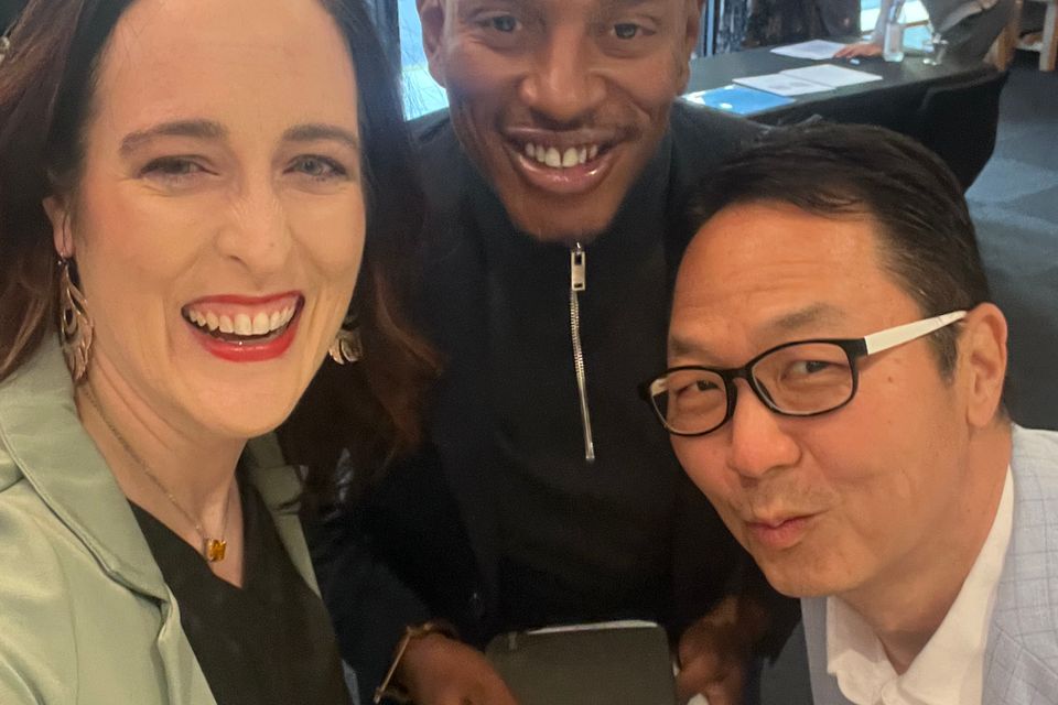 Two men and a woman smiling