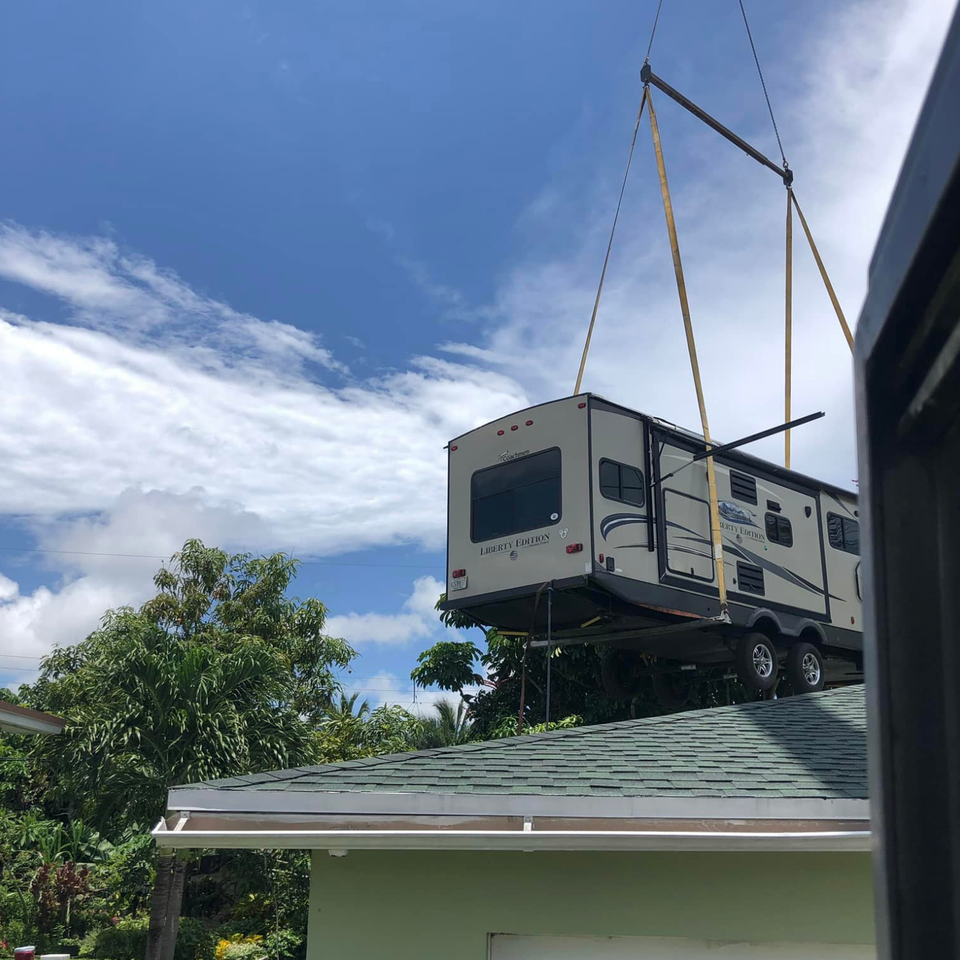 Lg crane services removing a camper from a broward home