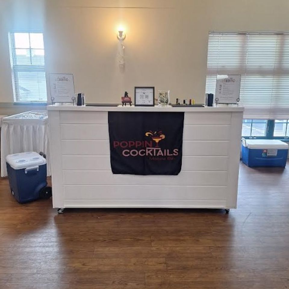 6ft wooden bar setup with menus, coolers, and supplies