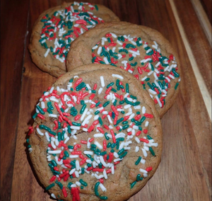 Three gingerbread Christmas cookies with red, white and green sprinkles.