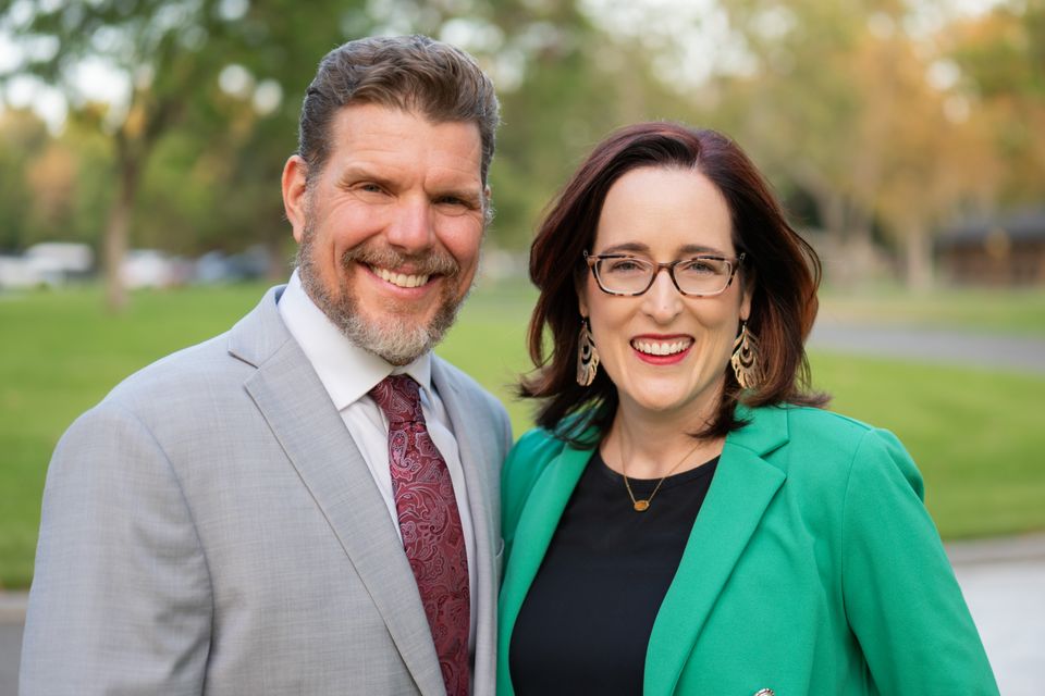 Man and woman posing outdoors