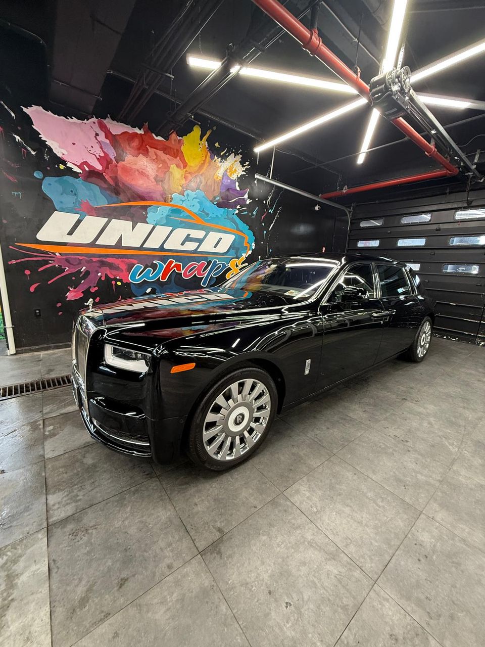 Professionally applied paint protection film on a black Bentley