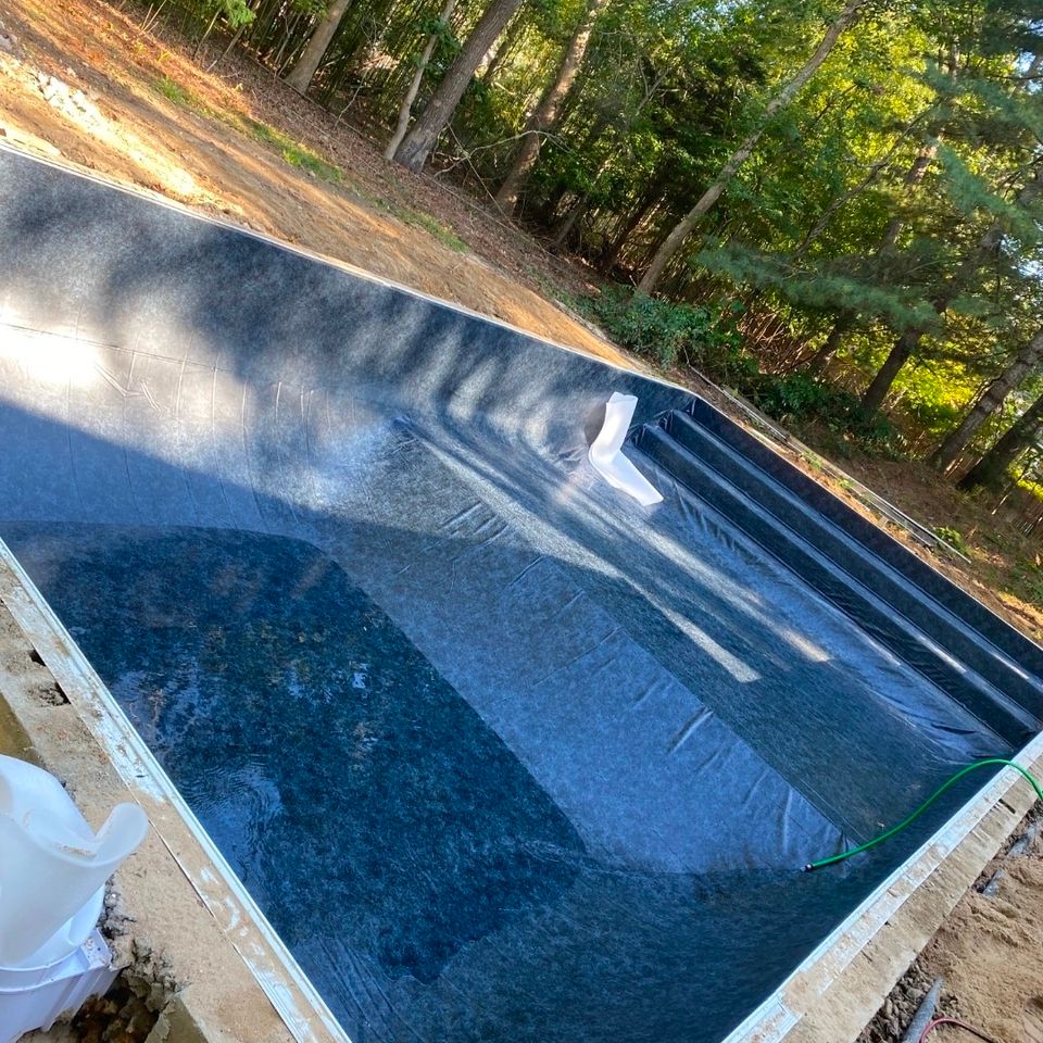 Dark liner installed in a rectangular inground pool during a liner replacement project
