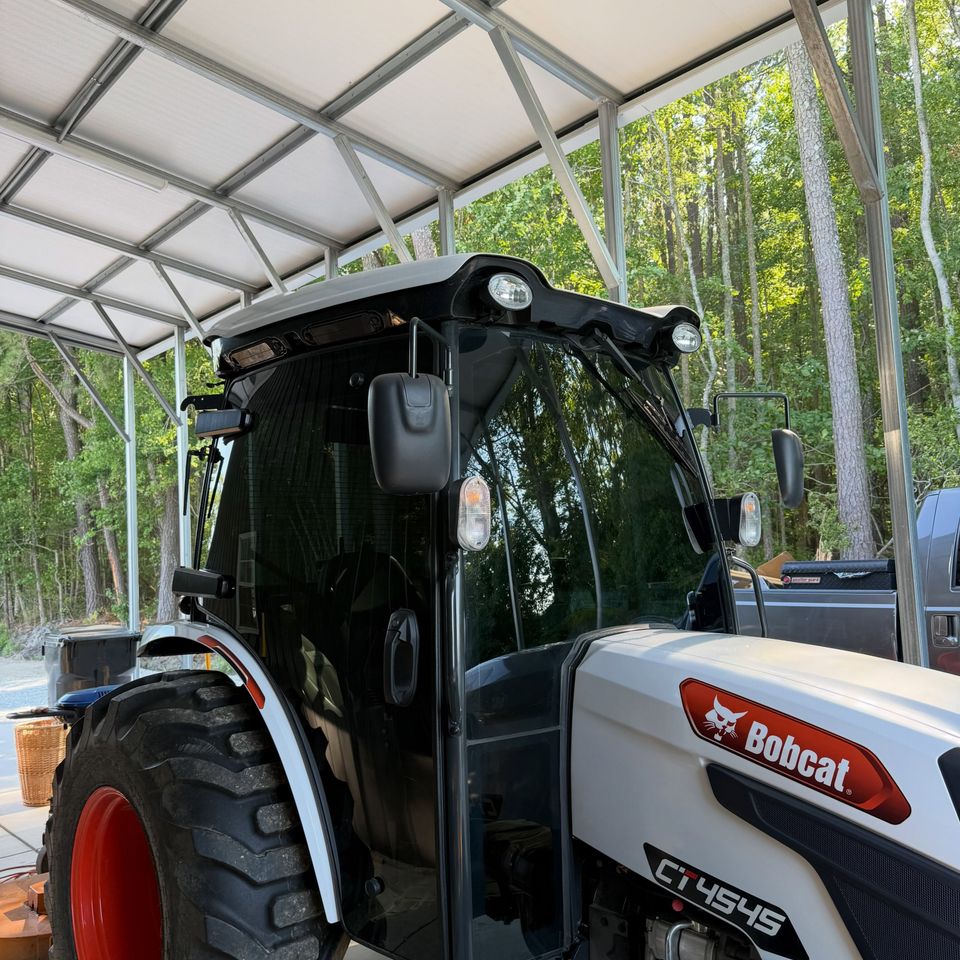 Bobcat CT4545 compact tractor cab with heavy equipment window tint on all glass panels at a Moyock NC property