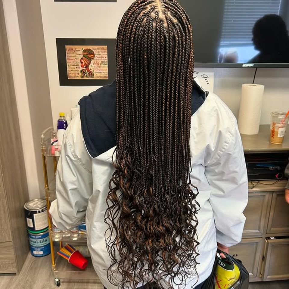 Long knotless braids with curly ends styled on a client in Los Angeles CA