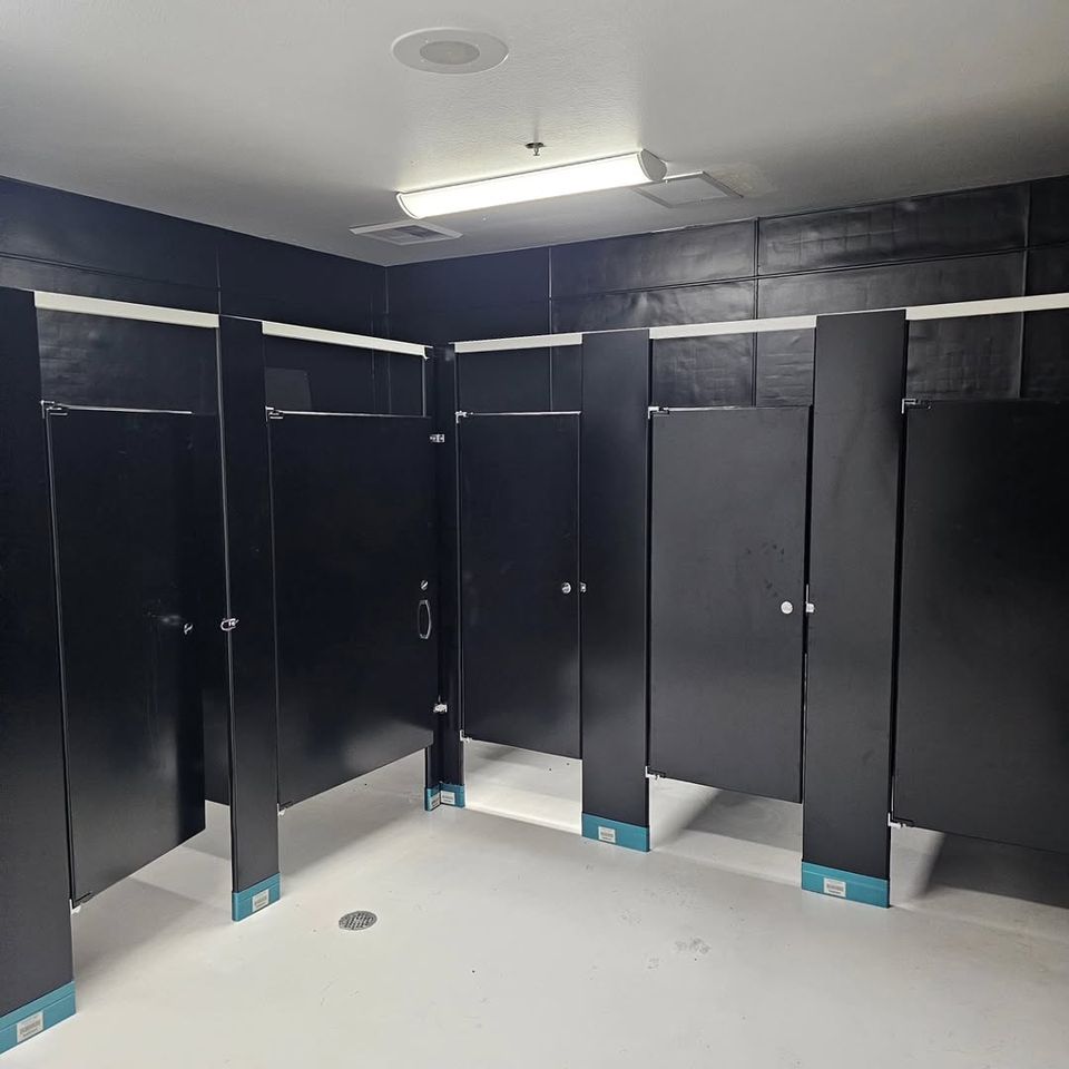 Black bathroom partitions installed by Pabst Leyton