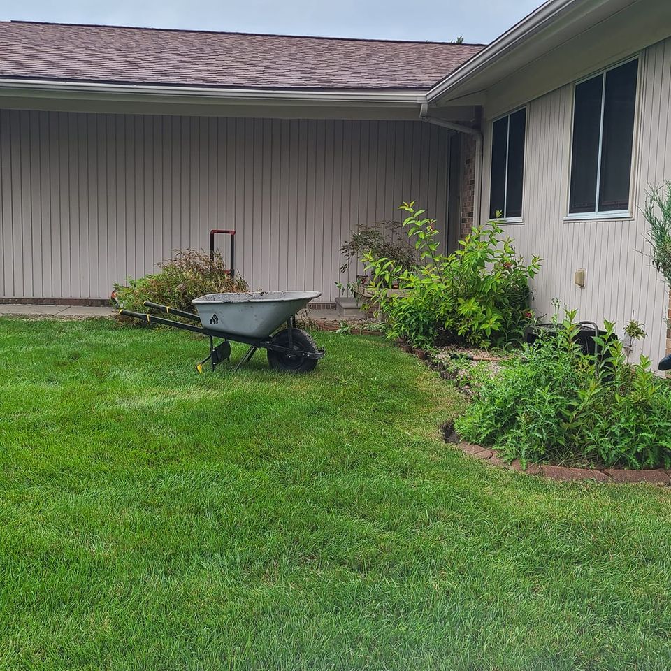 Side view of a house with recent landscaping done by Vic's Landscaping