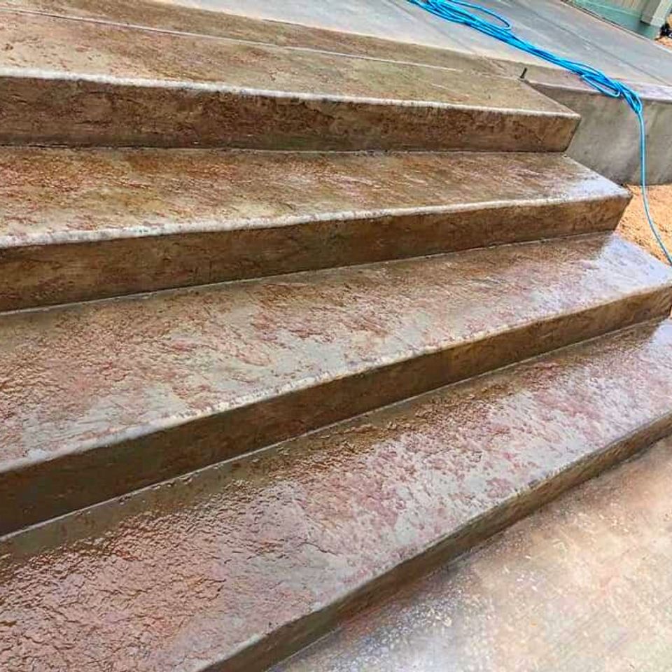 Custom tan earth-tone masonry steps and decorative backyard stairway integrated into a residential landscape design by Roseville Concrete Solutions.