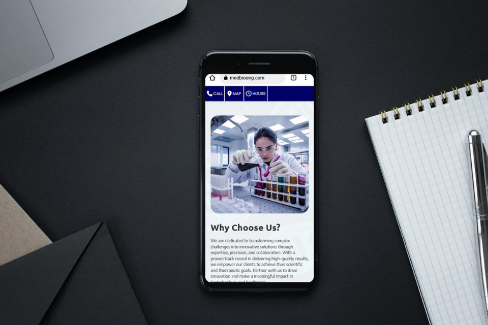 Smartphone displaying biotech company website at FITCI in Frederick Maryland with a scientist in lab and 'Why Choose Us' section focused on medical innovation.