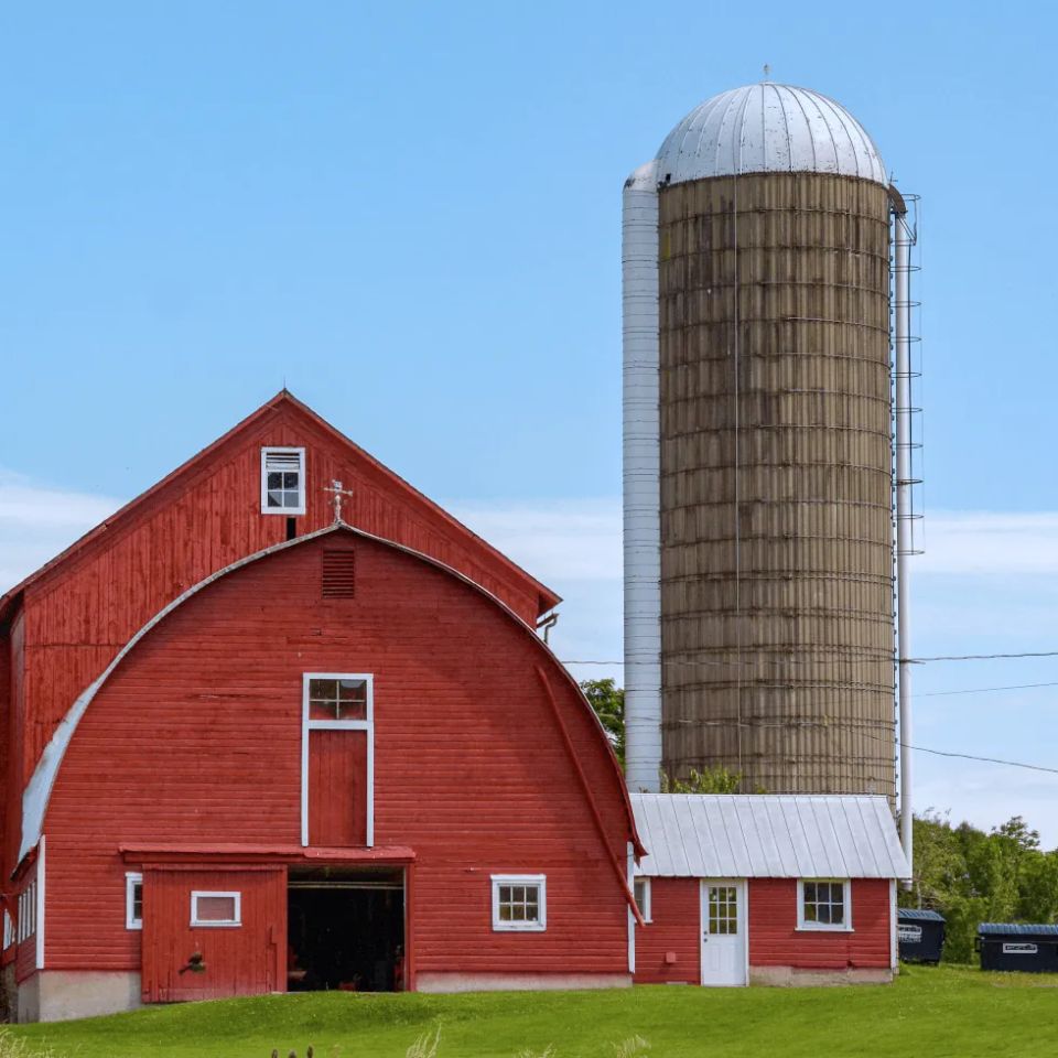 Red barn with large silo