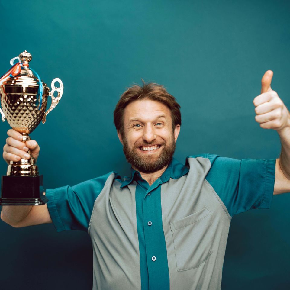 Smiling man getting trophy