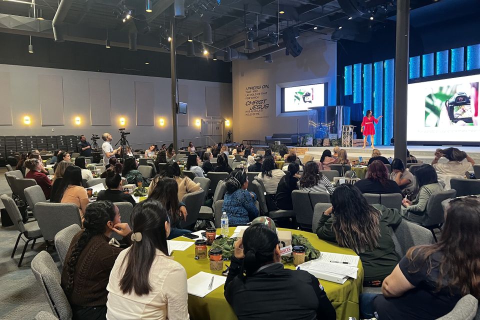 People seated at tables at an event