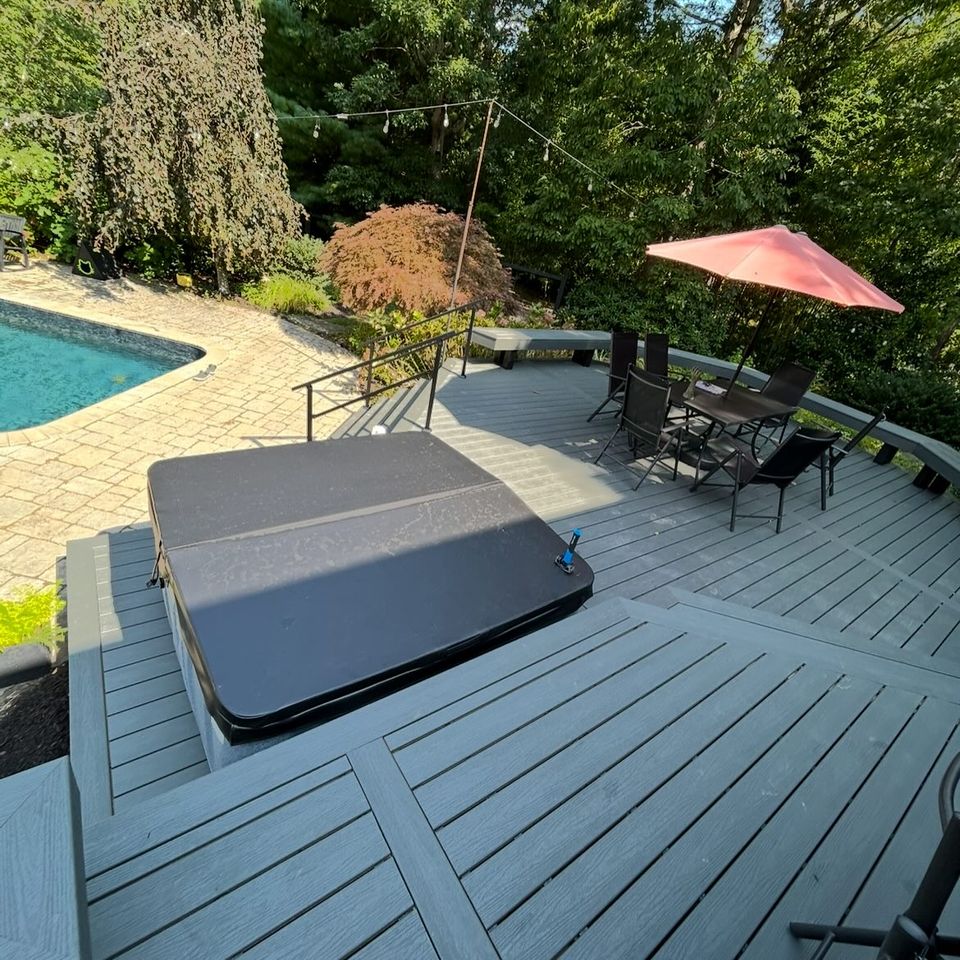 1200 sq ft trex enhance deck with pool in the background, done by J.B.T Contracting of Long Island, NY
