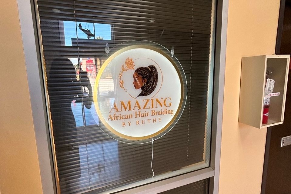Amazing African Hair Braiding by Ruthy window sign at the salon entrance in Los Angeles CA