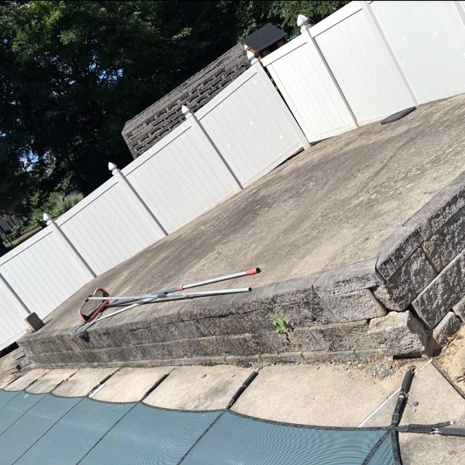 Concrete pool deck and retaining wall with pressure washing wand in Harrisburg PA