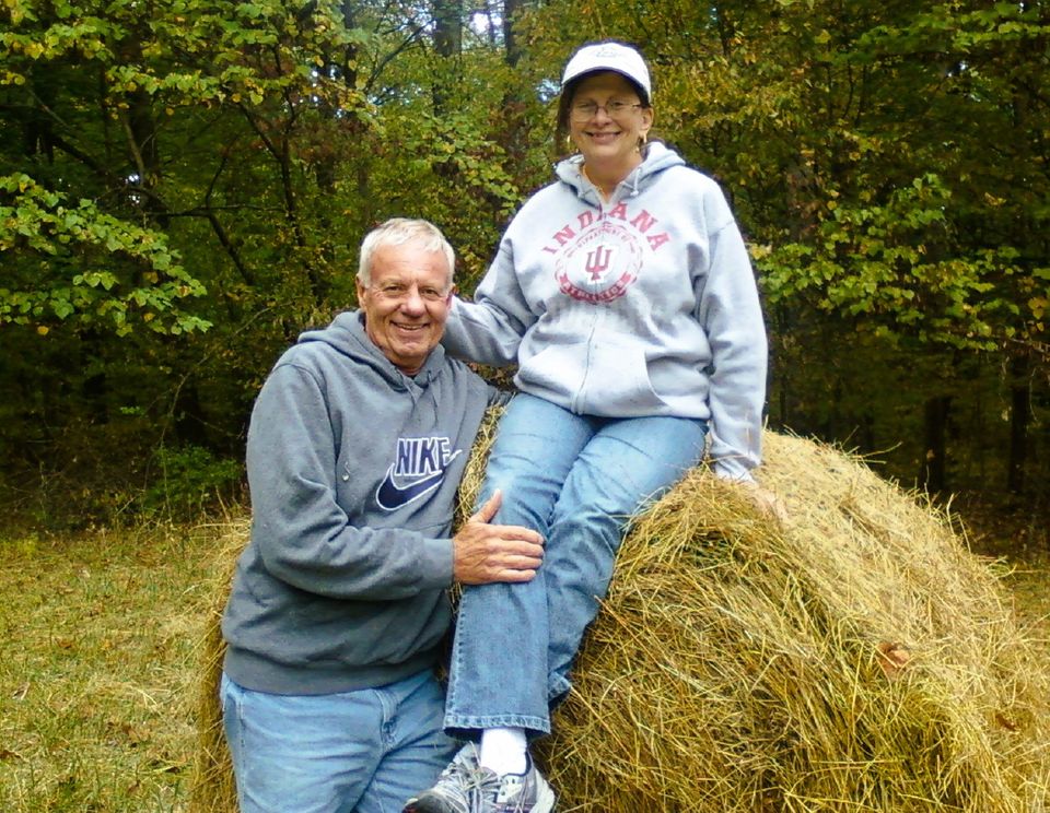 Pete and wife on bale of hay