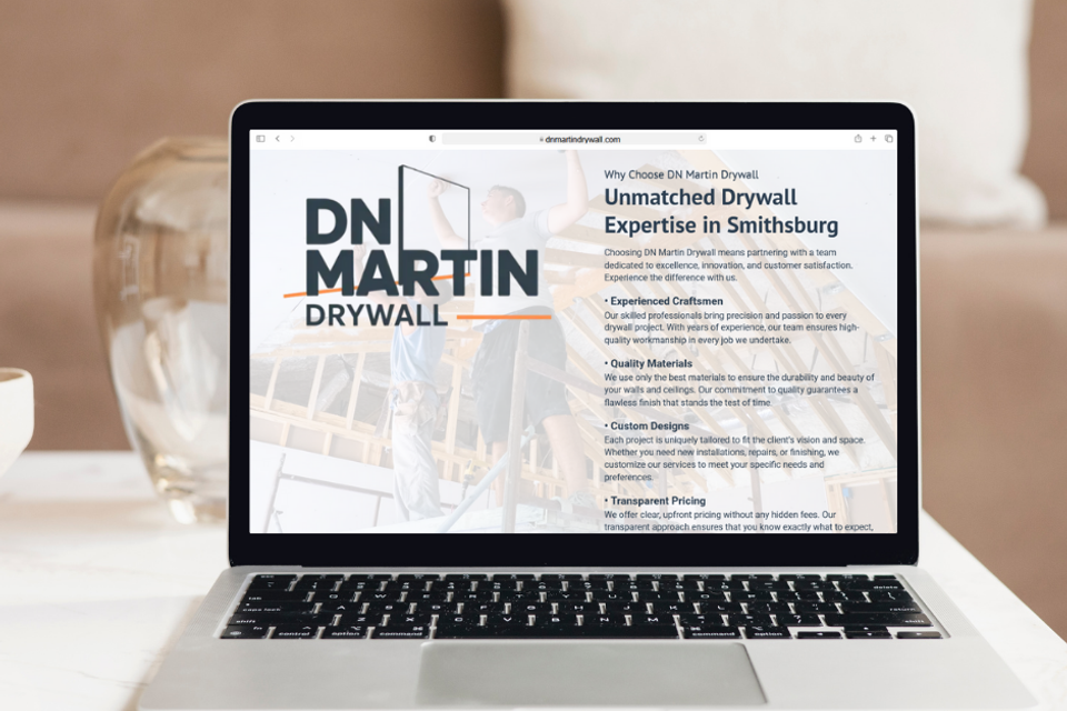 DN Martin Drywall website on laptop screen showcasing drywall expertise, quality materials, and service features for residential and commercial projects in Smithsburg Maryland.