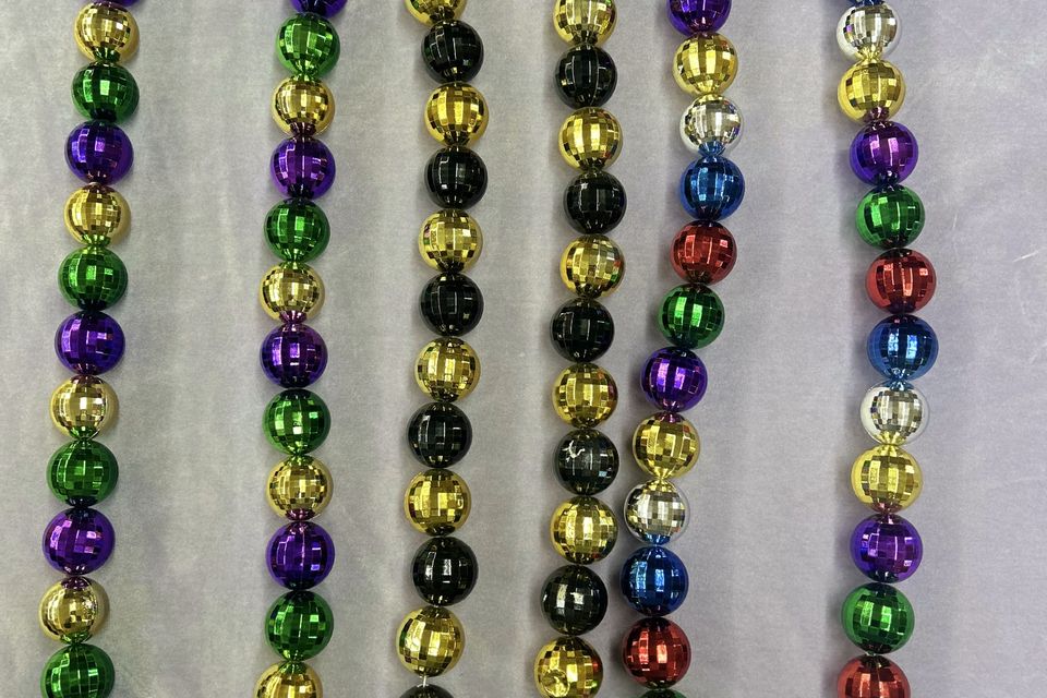Large round beads in purple, green and gold, black and gold, and multicolors.