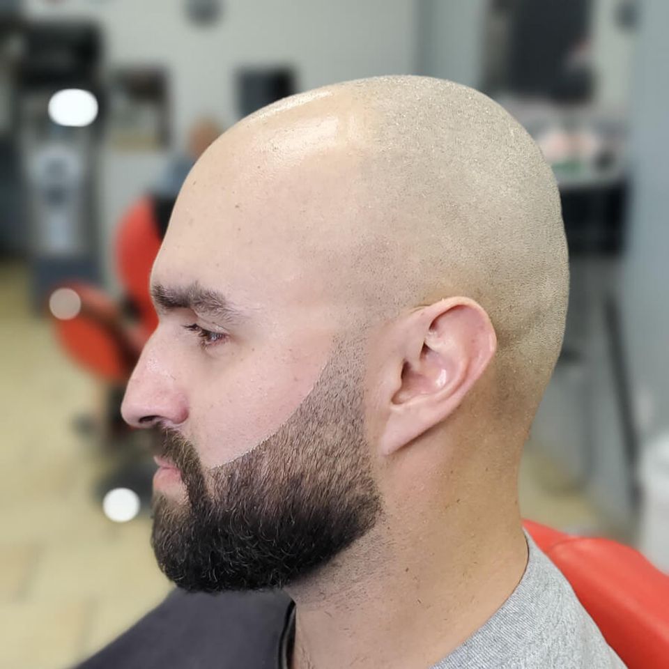 Middle aged client posing with his freshly shaped beard