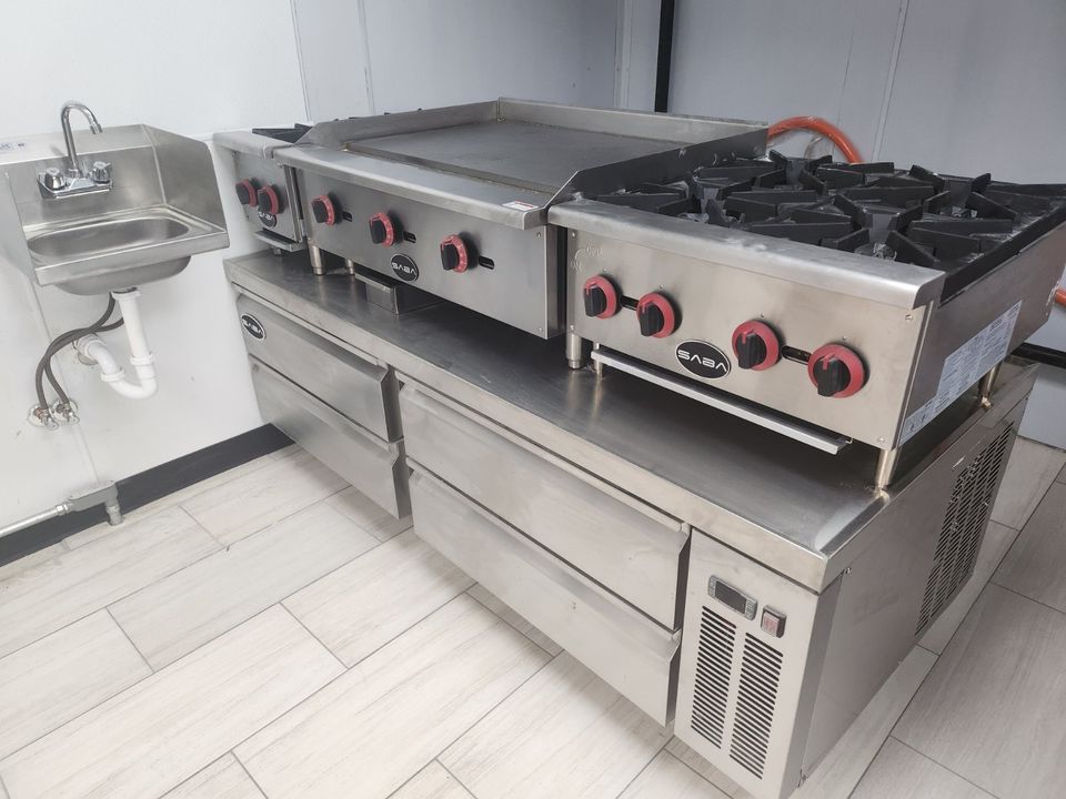 commercial restaurant food service kitchen with stainless steel hand sink, chef base, countertop 4 burner range and flat top grill griddle