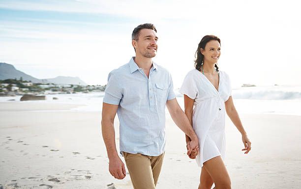 Fit couple walking on the beach