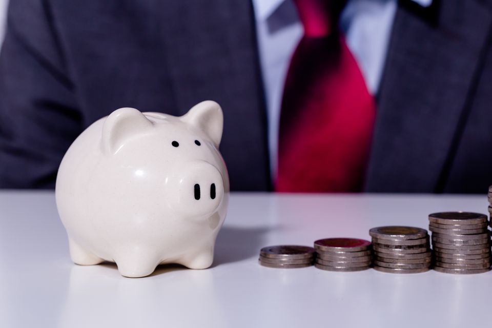 Businessman and stack of coins implying growth in 2025 01 29 05 49 21 utc