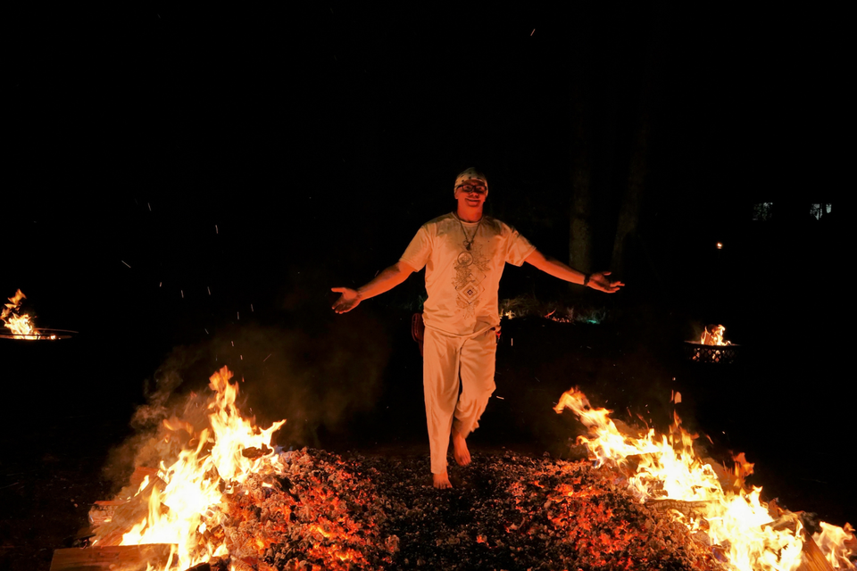 participant mid-stride across firewalk showing focus and determination