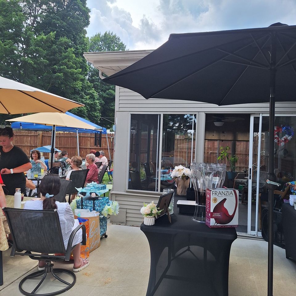 Outdoor baby shower setting with full bar setup