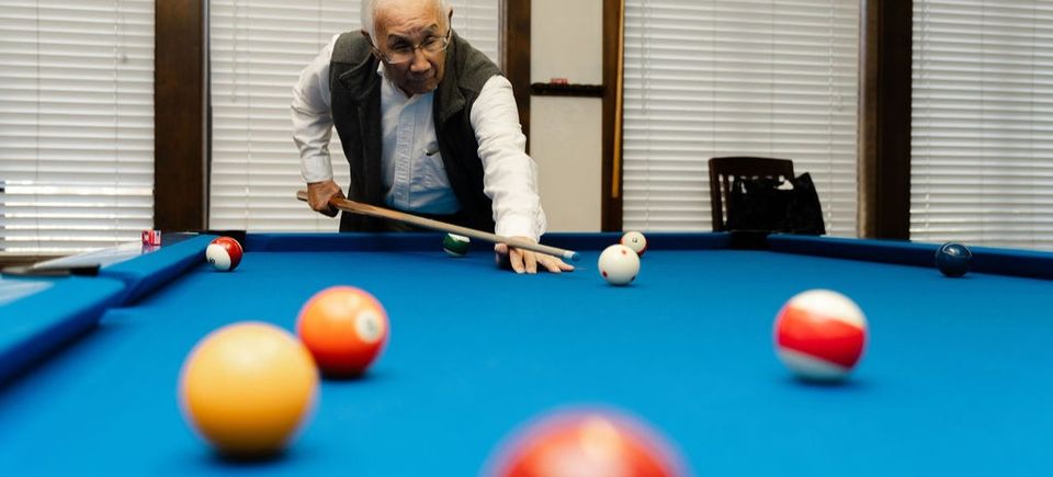 Billiards player shoots shot