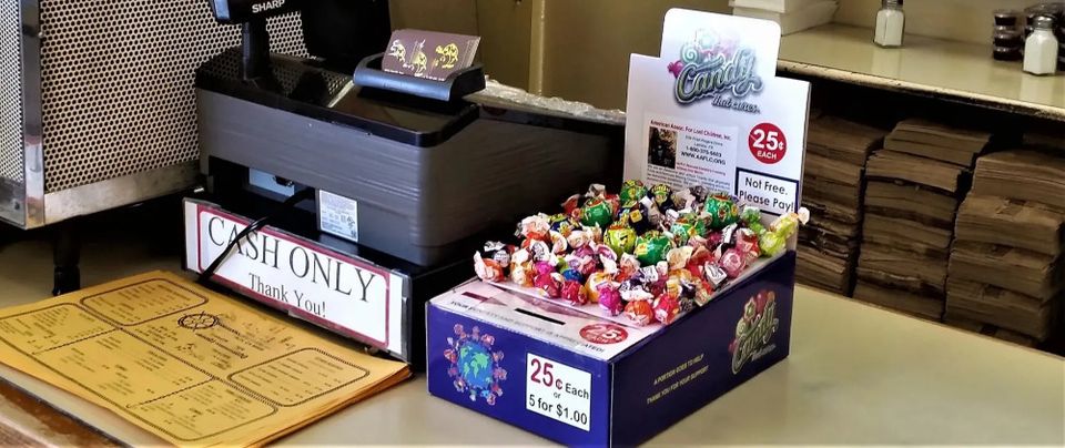 Honor box shown on counter top near cash register