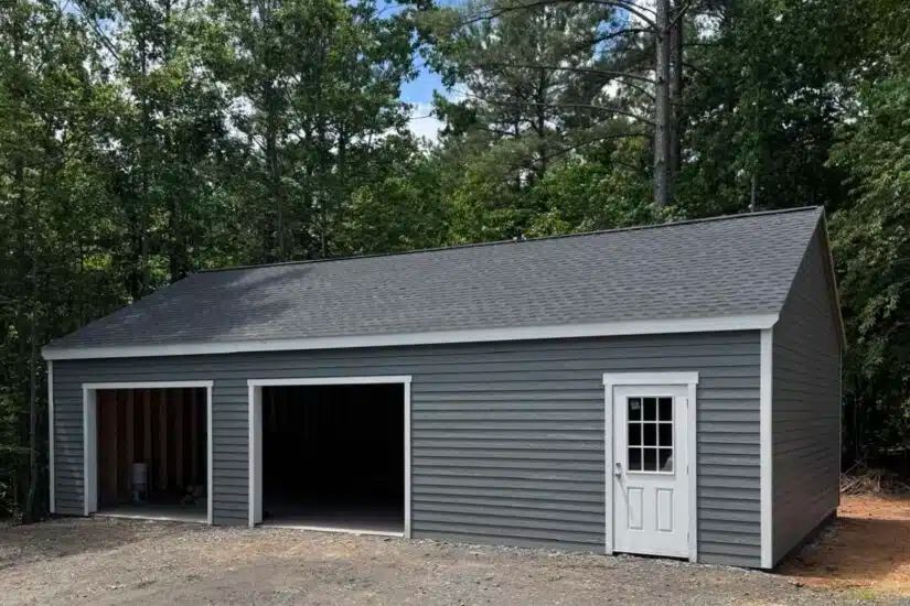 Gray double-wide garage with two open bays and shingle roof on a Knoxville TN property