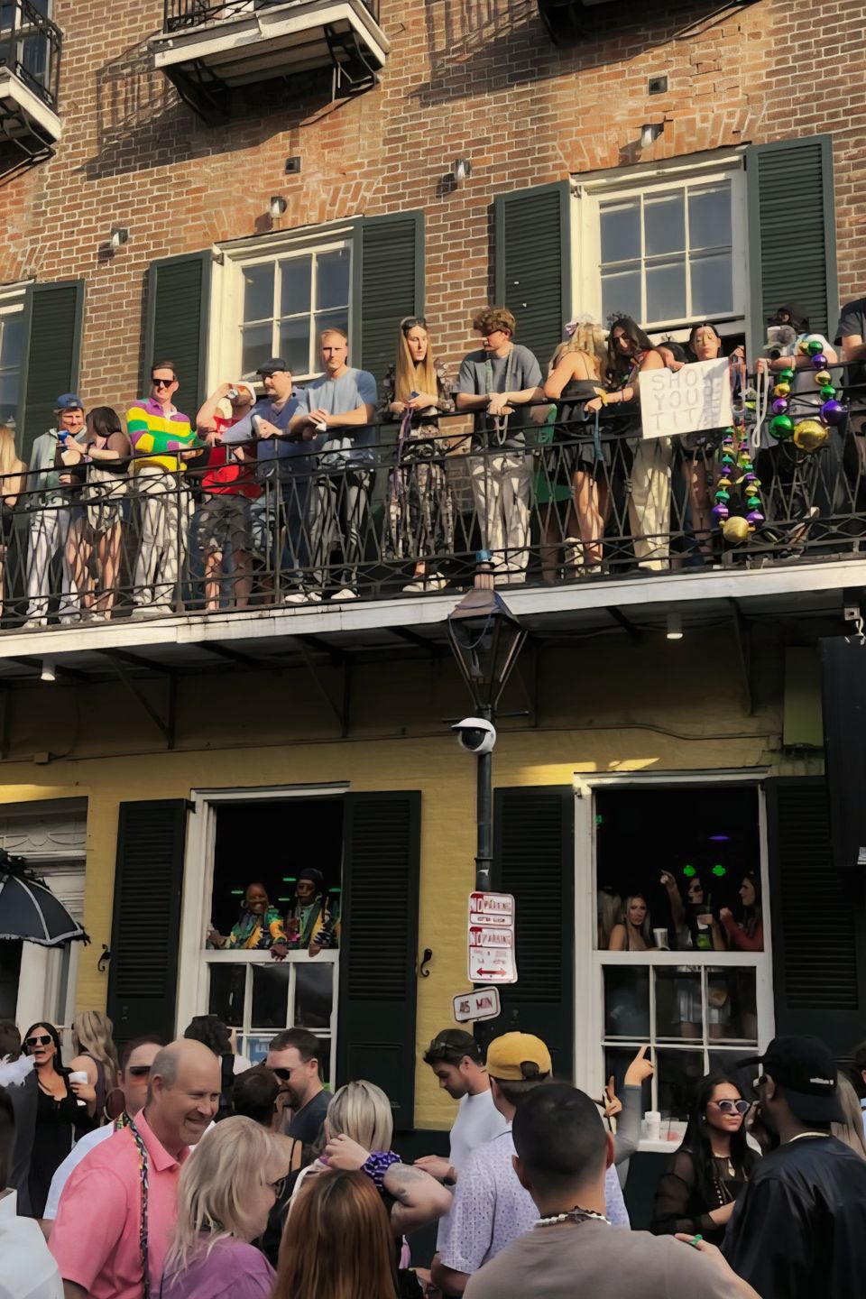 VIP Mardi Gras balcony at The Swamp 516 Bourbon Street overlooking the Bourbon Street crowds in New Orleans